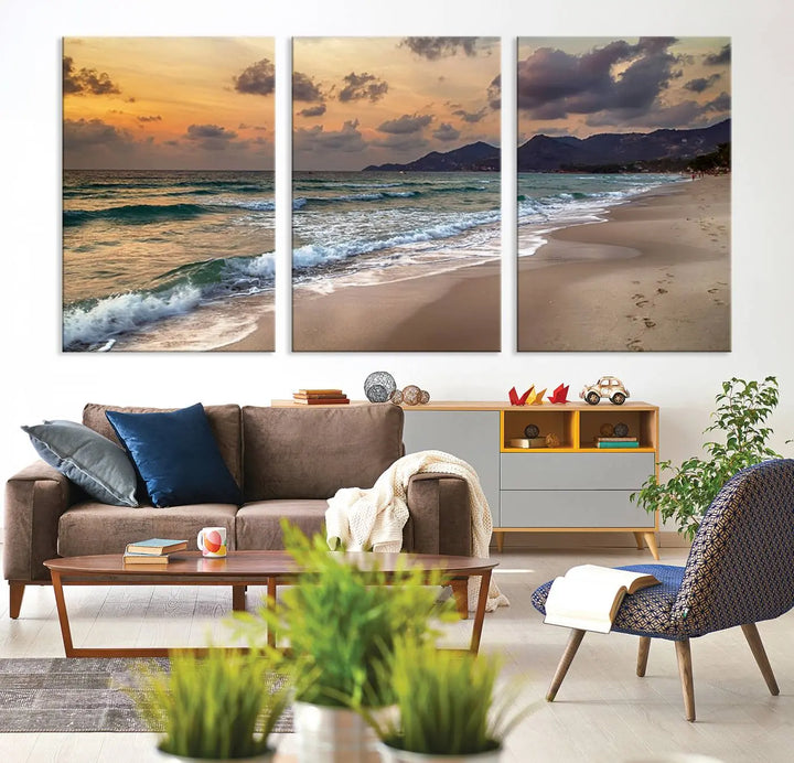 The Ocean Beach Wall Art Canvas Print, a stunning triptych featuring sunset artwork that captures waves and footprints on the sand, beautifully enhances any coastal decor.