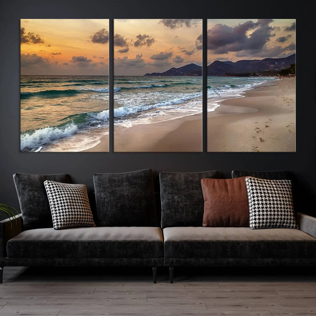 The Ocean Beach Wall Art Canvas Print, a stunning triptych featuring sunset artwork that captures waves and footprints on the sand, beautifully enhances any coastal decor.