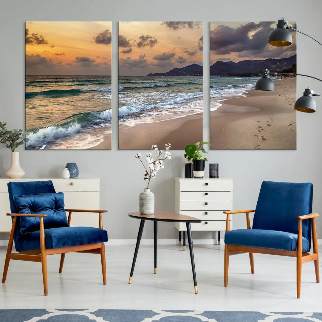 The Ocean Beach Wall Art Canvas Print, a stunning triptych featuring sunset artwork that captures waves and footprints on the sand, beautifully enhances any coastal decor.