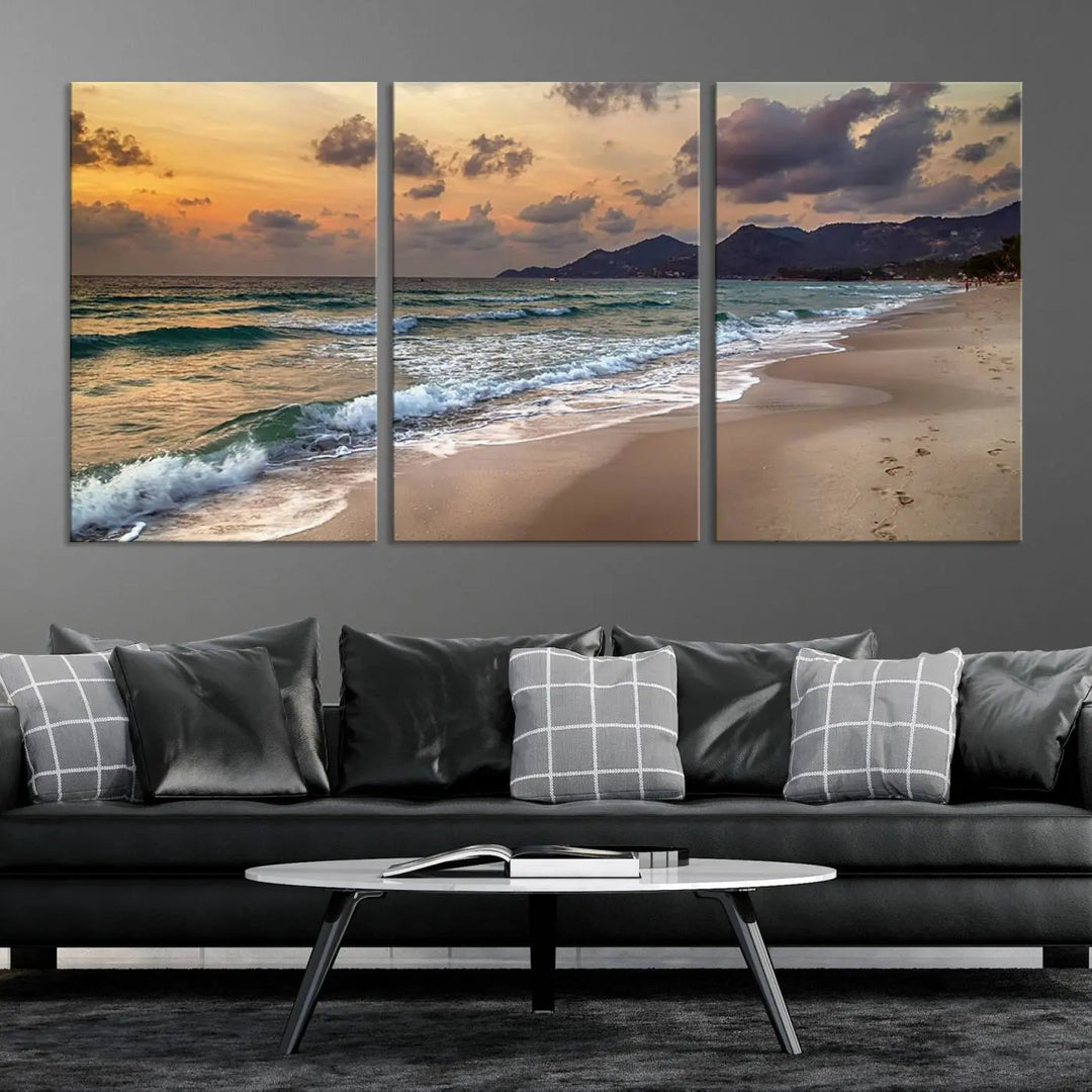 The Ocean Beach Wall Art Canvas Print, a stunning triptych featuring sunset artwork that captures waves and footprints on the sand, beautifully enhances any coastal decor.