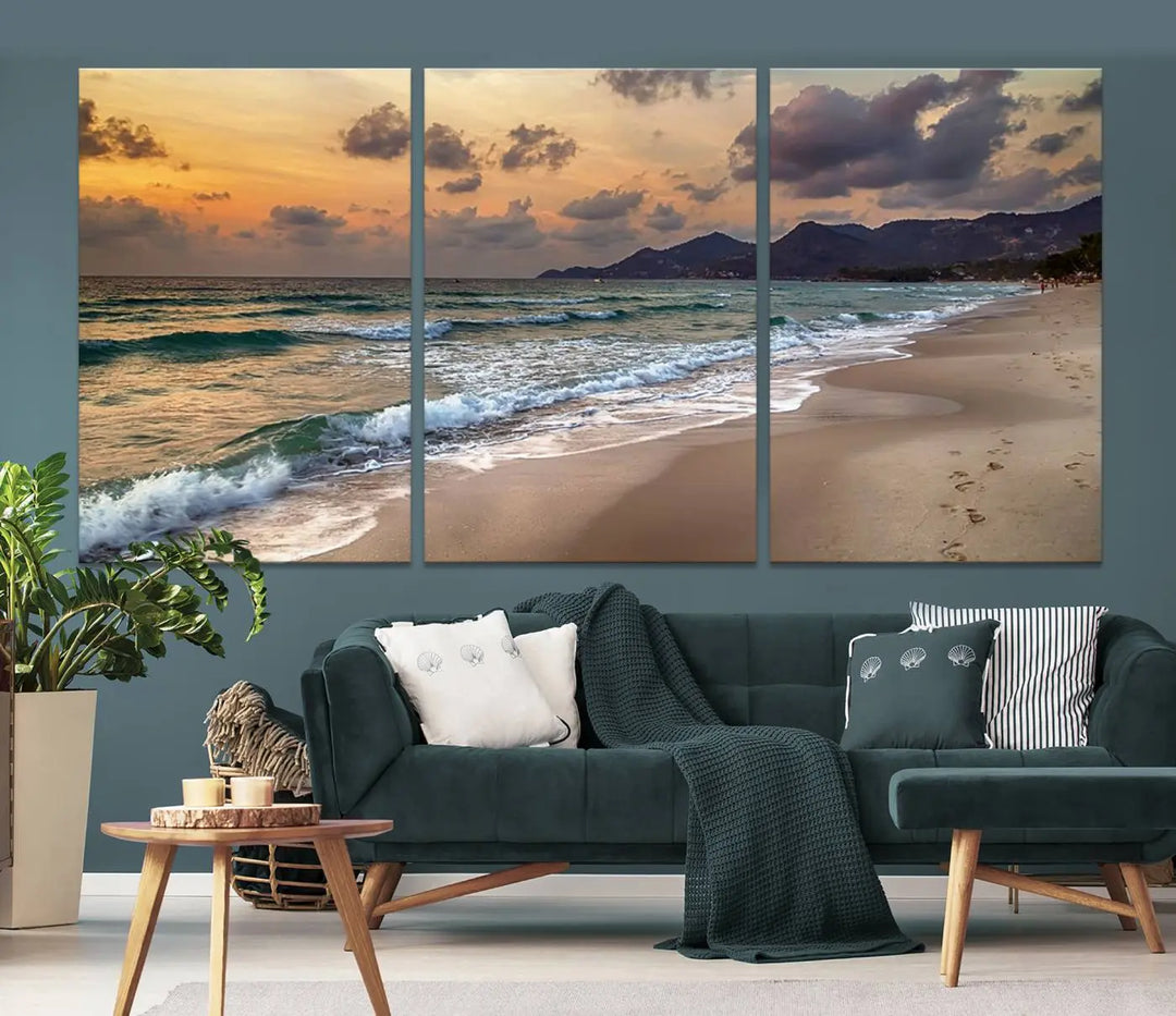 The Ocean Beach Wall Art Canvas Print, a stunning triptych featuring sunset artwork that captures waves and footprints on the sand, beautifully enhances any coastal decor.