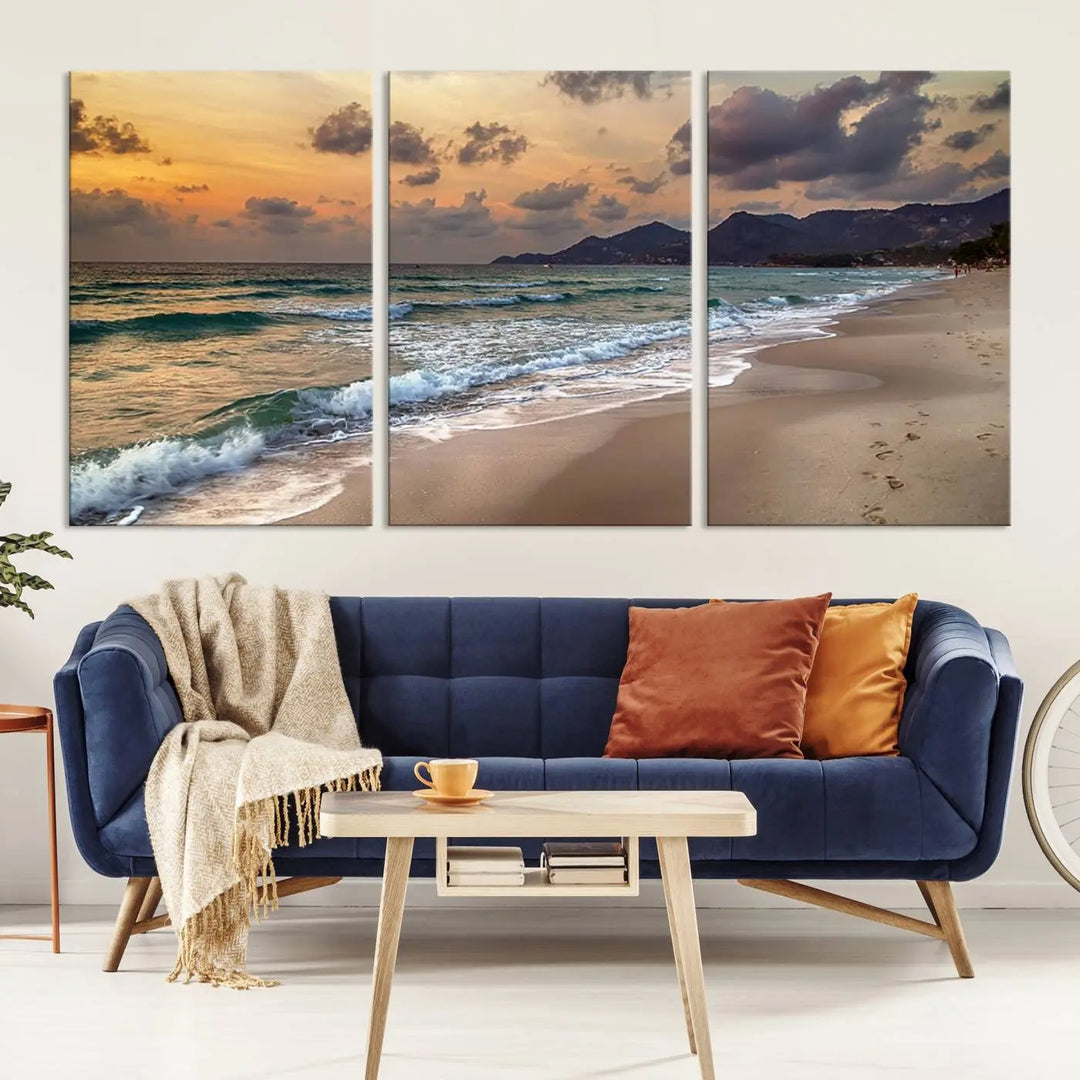 The Ocean Beach Wall Art Canvas Print, a stunning triptych featuring sunset artwork that captures waves and footprints on the sand, beautifully enhances any coastal decor.