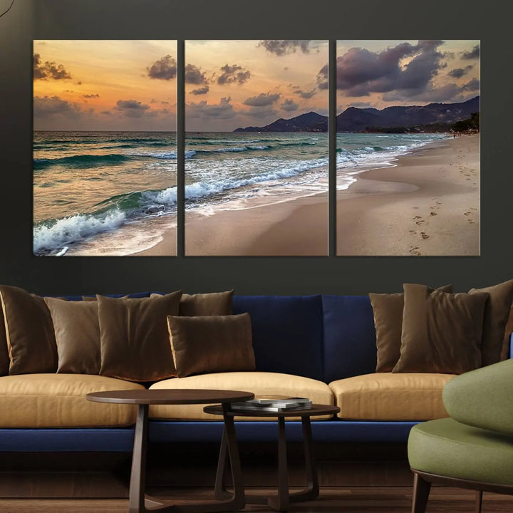 The Ocean Beach Wall Art Canvas Print, a stunning triptych featuring sunset artwork that captures waves and footprints on the sand, beautifully enhances any coastal decor.