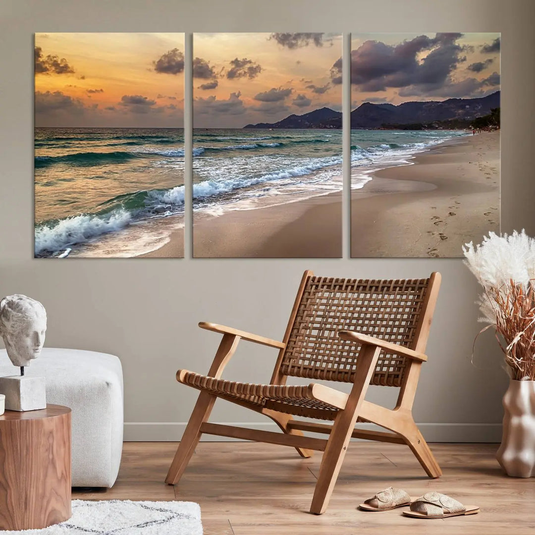 The Ocean Beach Wall Art Canvas Print, a stunning triptych featuring sunset artwork that captures waves and footprints on the sand, beautifully enhances any coastal decor.