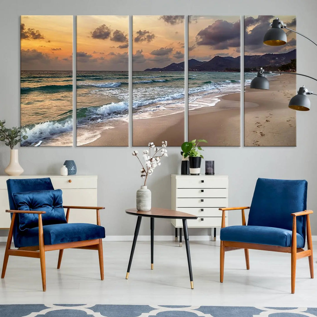 The Ocean Beach Wall Art Canvas Print, a stunning triptych featuring sunset artwork that captures waves and footprints on the sand, beautifully enhances any coastal decor.