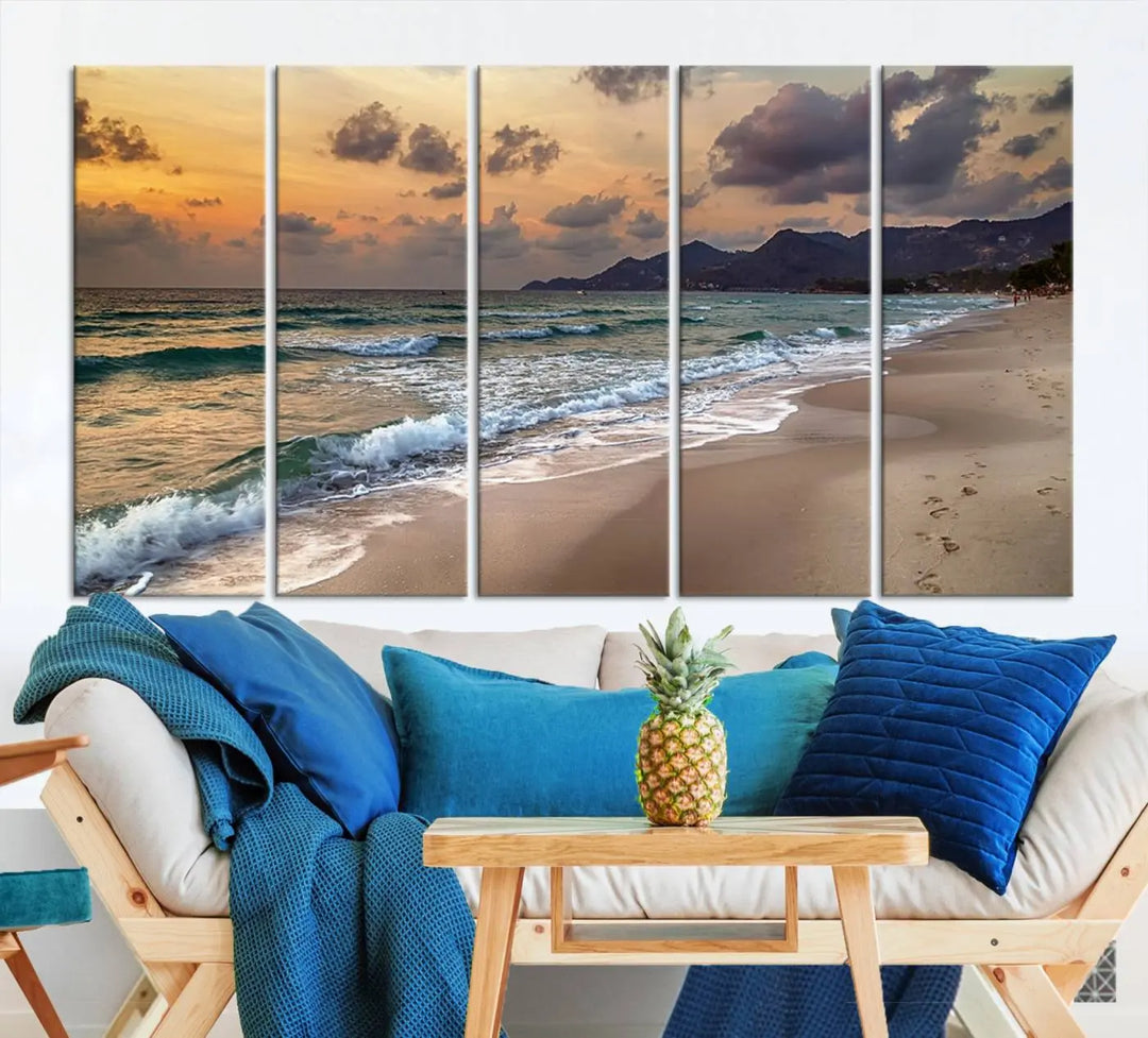 The Ocean Beach Wall Art Canvas Print, a stunning triptych featuring sunset artwork that captures waves and footprints on the sand, beautifully enhances any coastal decor.