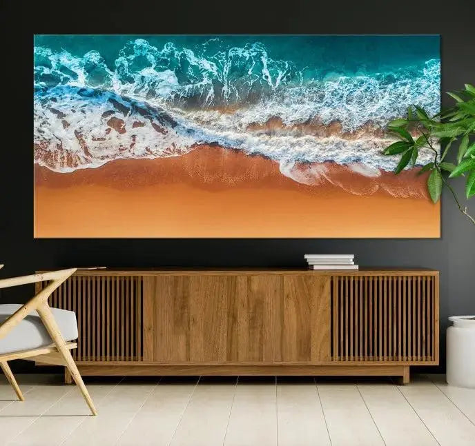 The "Ocean Beach Wall Art Nautical Landscape Canvas Print" is a stunning triptych of aerial ocean waves on museum-quality canvas with UV-protective coating. It's ready to hang and can instantly transform your space.