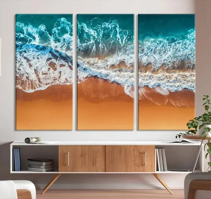 The "Ocean Beach Wall Art Nautical Landscape Canvas Print" is a stunning triptych of aerial ocean waves on museum-quality canvas with UV-protective coating. It's ready to hang and can instantly transform your space.