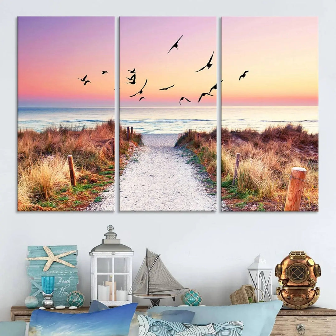 The "Ocean Pathway Sunset Canvas Art" beautifully depicts a tranquil coastal beach walk at sunset, featuring birds in flight across a vividly colorful sky. This piece is crafted using giclee print technology on canvas to ensure vibrant colors and exquisite detail for a relaxing wall art experience.