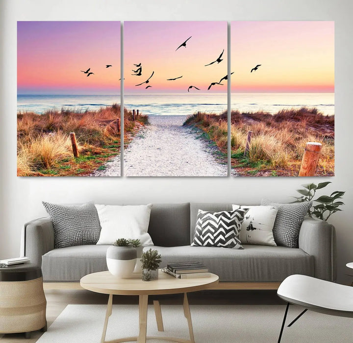 The "Ocean Pathway Sunset Canvas Art" beautifully depicts a tranquil coastal beach walk at sunset, featuring birds in flight across a vividly colorful sky. This piece is crafted using giclee print technology on canvas to ensure vibrant colors and exquisite detail for a relaxing wall art experience.