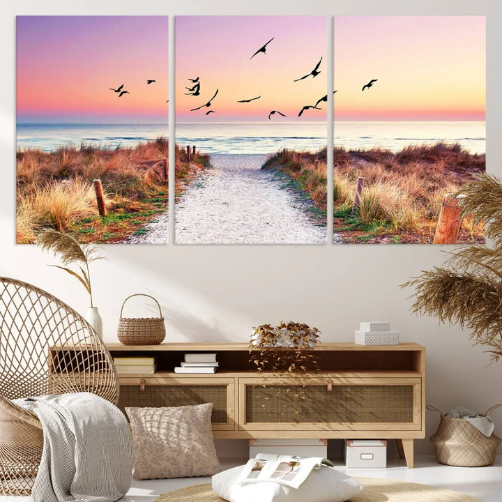 The "Ocean Pathway Sunset Canvas Art" beautifully depicts a tranquil coastal beach walk at sunset, featuring birds in flight across a vividly colorful sky. This piece is crafted using giclee print technology on canvas to ensure vibrant colors and exquisite detail for a relaxing wall art experience.