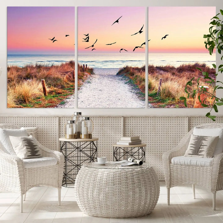 The "Ocean Pathway Sunset Canvas Art" beautifully depicts a tranquil coastal beach walk at sunset, featuring birds in flight across a vividly colorful sky. This piece is crafted using giclee print technology on canvas to ensure vibrant colors and exquisite detail for a relaxing wall art experience.