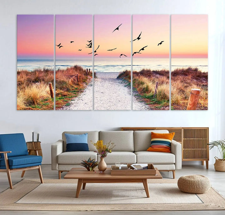 The "Ocean Pathway Sunset Canvas Art" beautifully depicts a tranquil coastal beach walk at sunset, featuring birds in flight across a vividly colorful sky. This piece is crafted using giclee print technology on canvas to ensure vibrant colors and exquisite detail for a relaxing wall art experience.