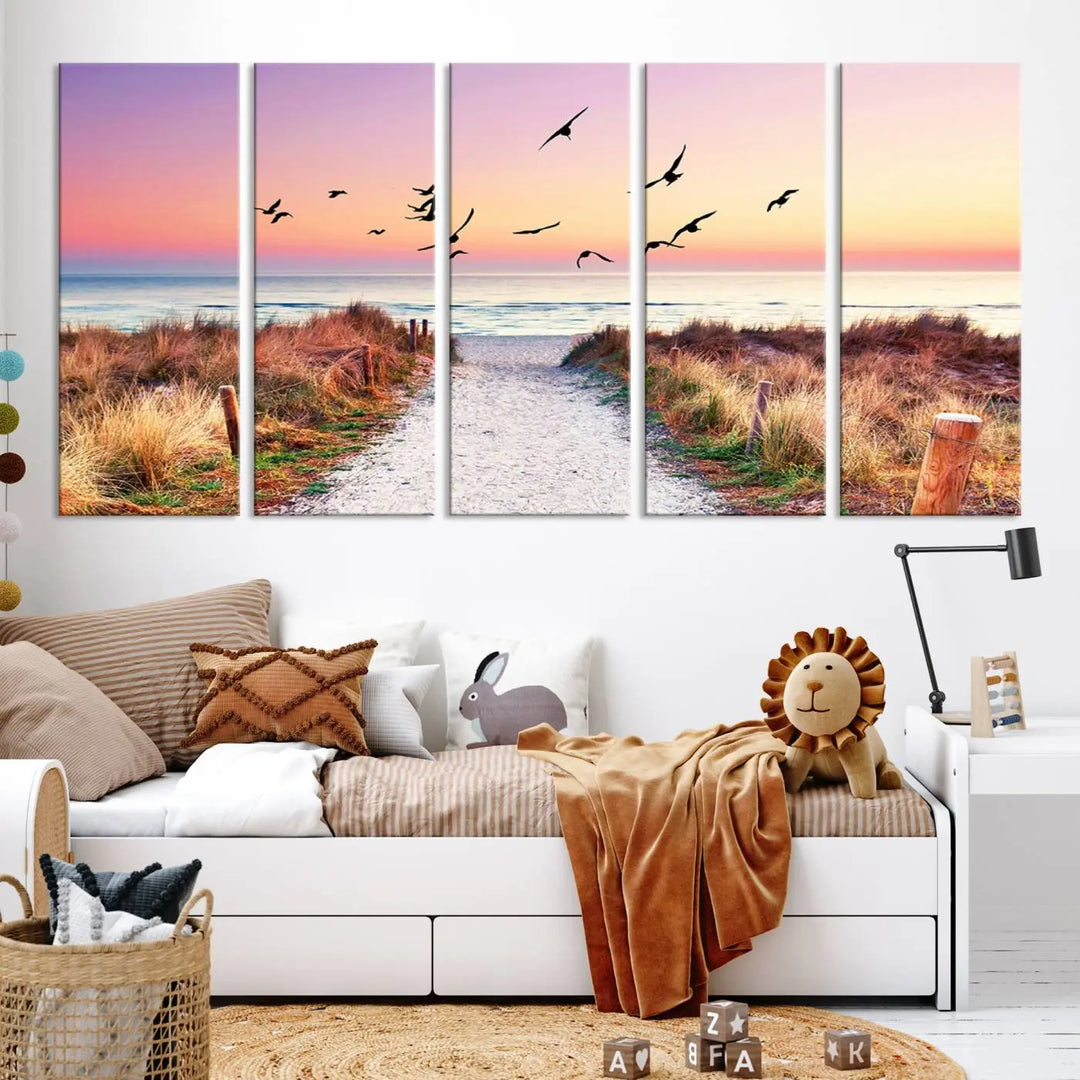 The "Ocean Pathway Sunset Canvas Art" beautifully depicts a tranquil coastal beach walk at sunset, featuring birds in flight across a vividly colorful sky. This piece is crafted using giclee print technology on canvas to ensure vibrant colors and exquisite detail for a relaxing wall art experience.