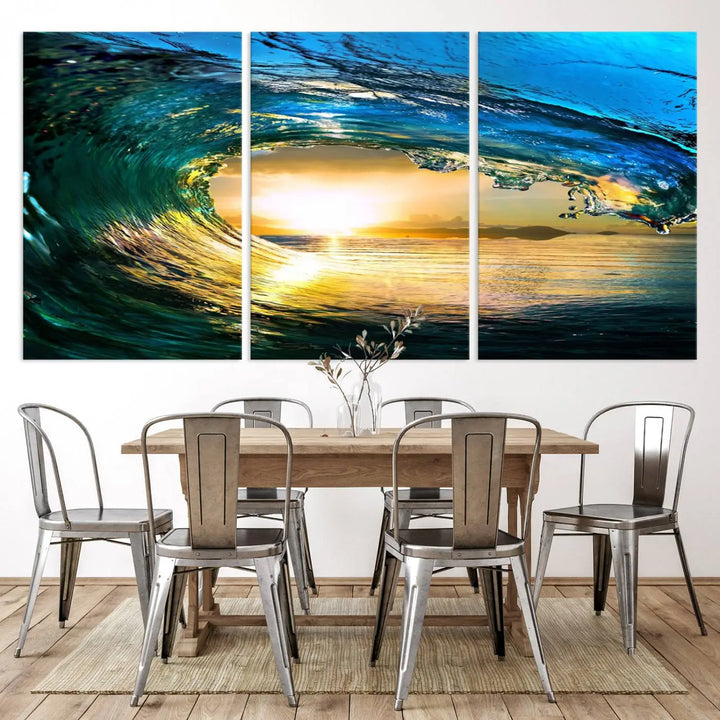 A modern dining room with a coastal vibe showcases a striking large wall print, the "Ocean Wave at Sunset Canvas Art," depicting vibrant water waves. The room features abstract wave artwork on the walls. This eye-catching piece of coastal art infuses the space with seaside serenity.