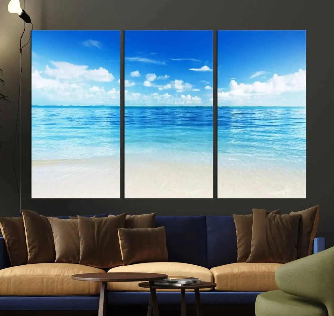 An Ocean and Beach Artwork Canvas Print Wall Art, divided into a triptych and crafted on museum-quality canvases ready to hang, decorates the wall.