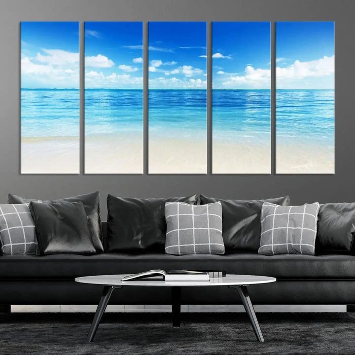 An Ocean and Beach Artwork Canvas Print Wall Art, divided into a triptych and crafted on museum-quality canvases ready to hang, decorates the wall.