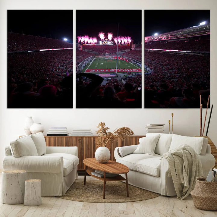 The living room features a breathtaking Ohio State University Buckeyes Football Team Print, depicting a stadium packed with fans, fireworks illuminating the sky, and Ohio State on the field. This Columbus Ohio Stadium Wall Art Canvas Print offers a vibrant display with a gallery-quality finish that instantly draws attention.