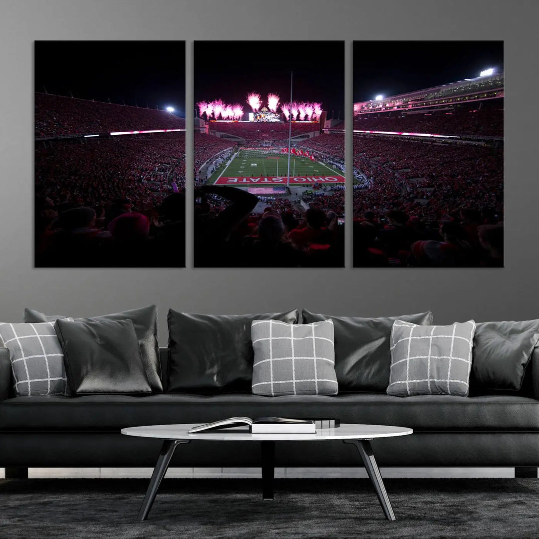 The living room features a breathtaking Ohio State University Buckeyes Football Team Print, depicting a stadium packed with fans, fireworks illuminating the sky, and Ohio State on the field. This Columbus Ohio Stadium Wall Art Canvas Print offers a vibrant display with a gallery-quality finish that instantly draws attention.