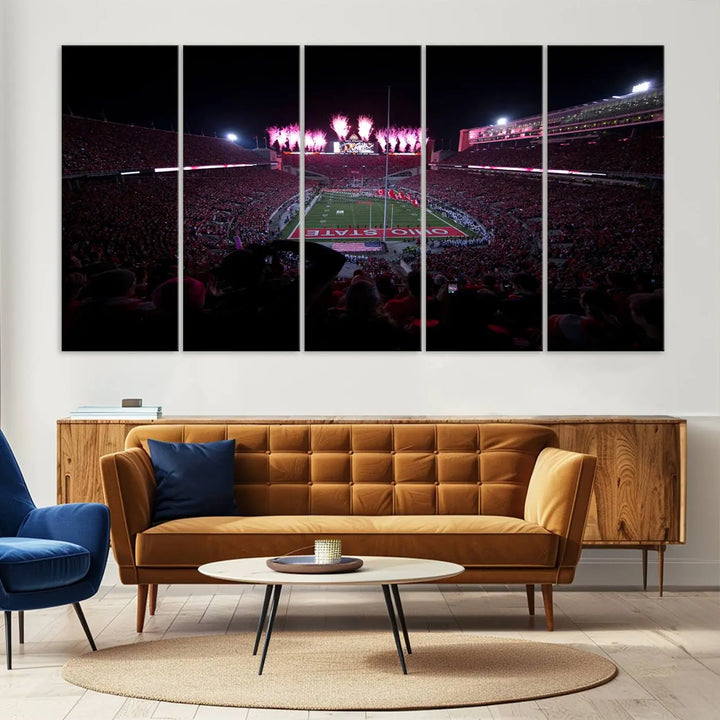 The living room features a breathtaking Ohio State University Buckeyes Football Team Print, depicting a stadium packed with fans, fireworks illuminating the sky, and Ohio State on the field. This Columbus Ohio Stadium Wall Art Canvas Print offers a vibrant display with a gallery-quality finish that instantly draws attention.