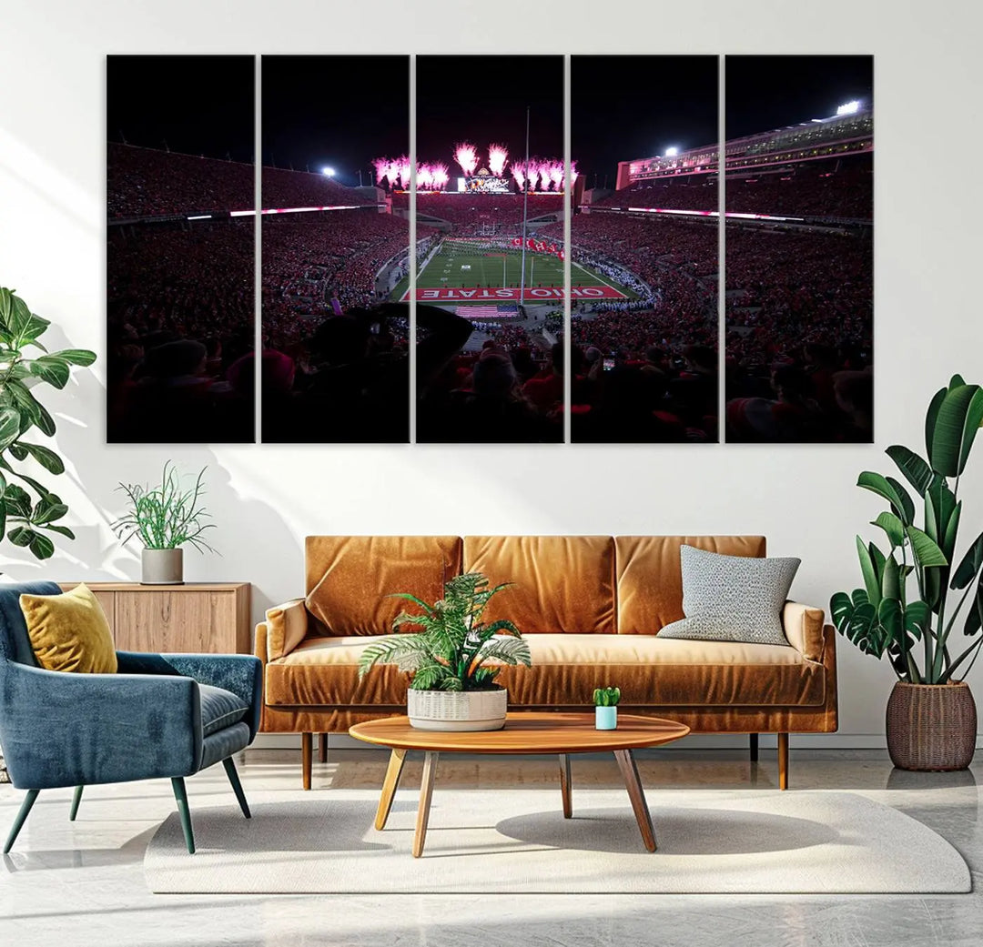 The living room features a breathtaking Ohio State University Buckeyes Football Team Print, depicting a stadium packed with fans, fireworks illuminating the sky, and Ohio State on the field. This Columbus Ohio Stadium Wall Art Canvas Print offers a vibrant display with a gallery-quality finish that instantly draws attention.