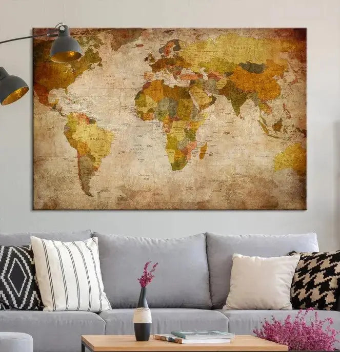 The Old Antique World Map Wall Art Canvas Print, featuring a three-panel vintage design and crafted with museum-quality canvas and UV-protective coating, hangs elegantly against a dark wall.