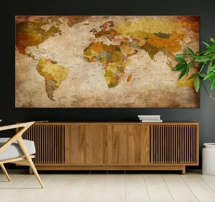 The Old Antique World Map Wall Art Canvas Print, featuring a three-panel vintage design and crafted with museum-quality canvas and UV-protective coating, hangs elegantly against a dark wall.