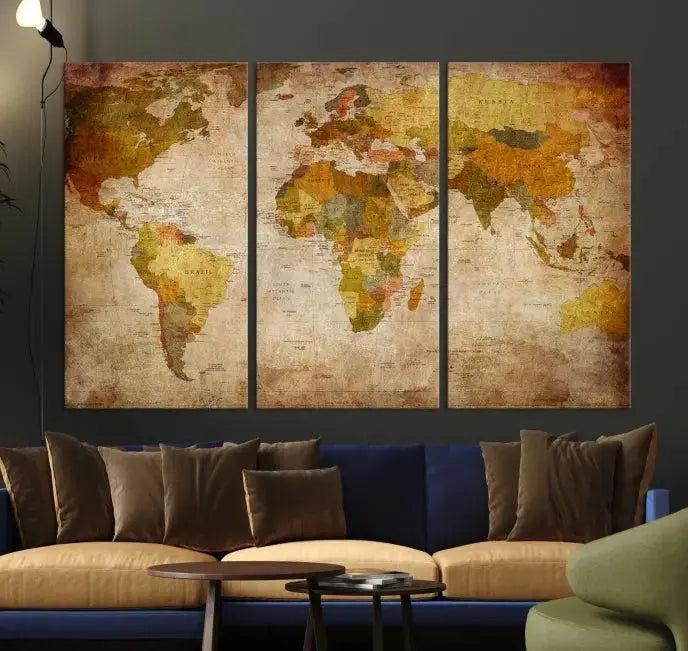 The Old Antique World Map Wall Art Canvas Print, featuring a three-panel vintage design and crafted with museum-quality canvas and UV-protective coating, hangs elegantly against a dark wall.