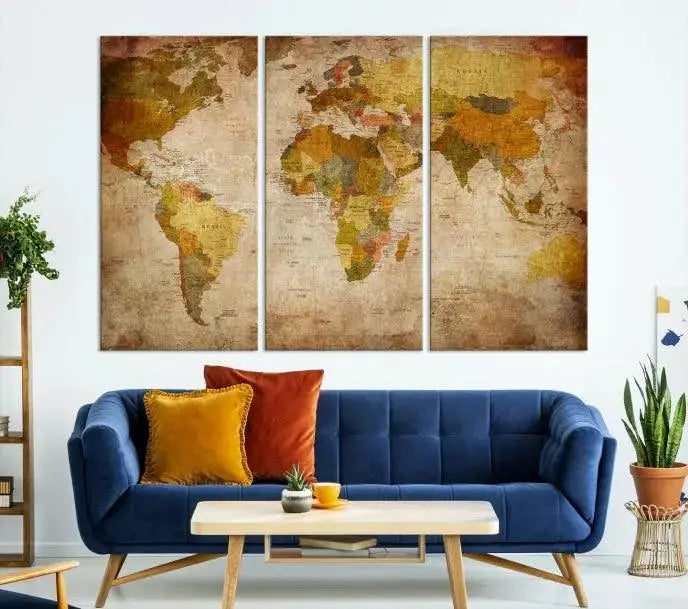 The Old Antique World Map Wall Art Canvas Print, featuring a three-panel vintage design and crafted with museum-quality canvas and UV-protective coating, hangs elegantly against a dark wall.