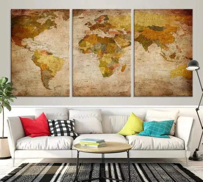 The Old Antique World Map Wall Art Canvas Print, featuring a three-panel vintage design and crafted with museum-quality canvas and UV-protective coating, hangs elegantly against a dark wall.