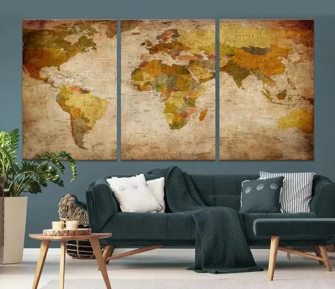 The Old Antique World Map Wall Art Canvas Print, featuring a three-panel vintage design and crafted with museum-quality canvas and UV-protective coating, hangs elegantly against a dark wall.