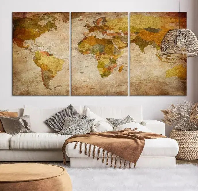 The Old Antique World Map Wall Art Canvas Print, featuring a three-panel vintage design and crafted with museum-quality canvas and UV-protective coating, hangs elegantly against a dark wall.