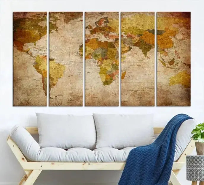 The Old Antique World Map Wall Art Canvas Print, featuring a three-panel vintage design and crafted with museum-quality canvas and UV-protective coating, hangs elegantly against a dark wall.