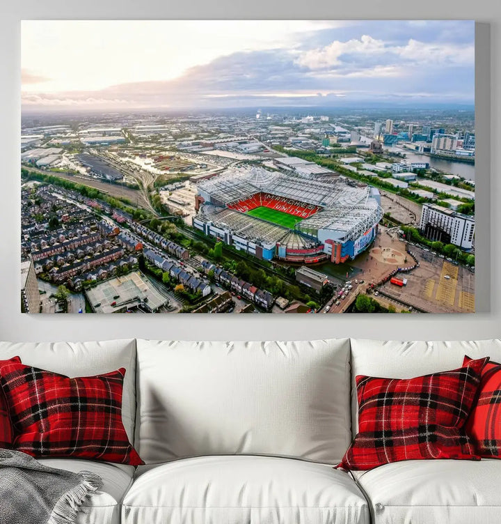 The "Old Trafford Manchester United Stadium Wall Art Canvas Print" adorns the room, showcasing an aerial view of Old Trafford at sunset. This three-panel wall art is perfect for any devoted Manchester United football fan.