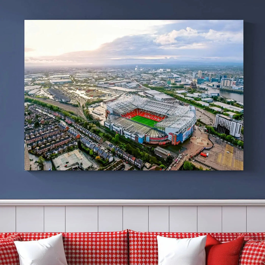 The "Old Trafford Manchester United Stadium Wall Art Canvas Print" adorns the room, showcasing an aerial view of Old Trafford at sunset. This three-panel wall art is perfect for any devoted Manchester United football fan.