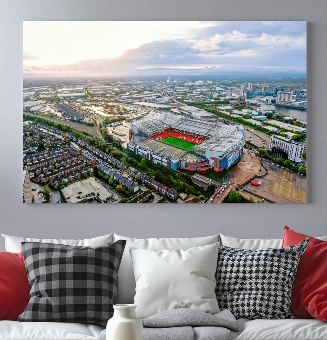 The "Old Trafford Manchester United Stadium Wall Art Canvas Print" adorns the room, showcasing an aerial view of Old Trafford at sunset. This three-panel wall art is perfect for any devoted Manchester United football fan.