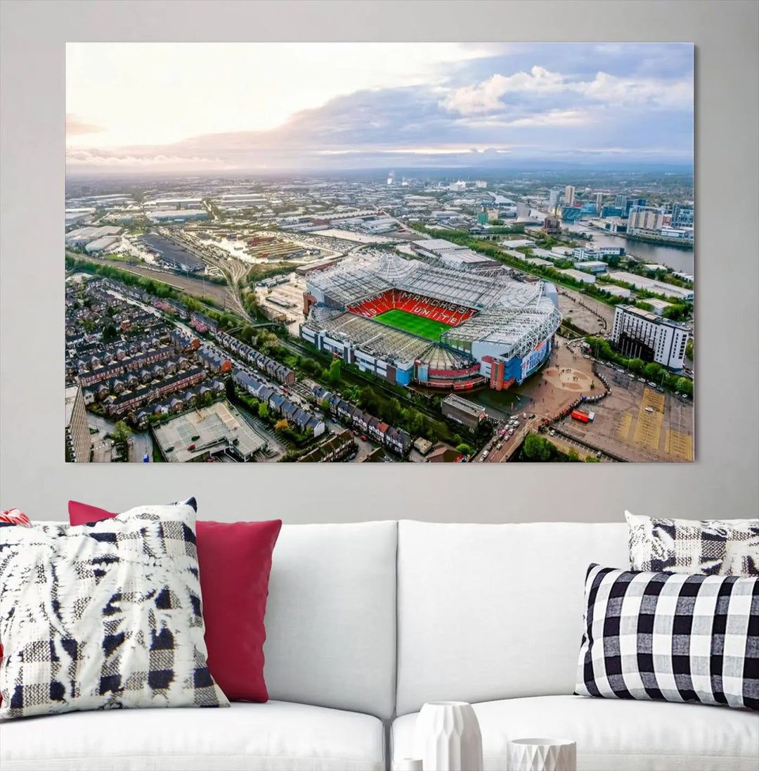 The "Old Trafford Manchester United Stadium Wall Art Canvas Print" adorns the room, showcasing an aerial view of Old Trafford at sunset. This three-panel wall art is perfect for any devoted Manchester United football fan.