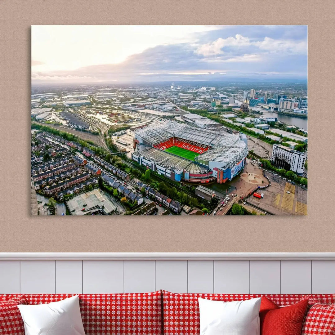 The "Old Trafford Manchester United Stadium Wall Art Canvas Print" adorns the room, showcasing an aerial view of Old Trafford at sunset. This three-panel wall art is perfect for any devoted Manchester United football fan.