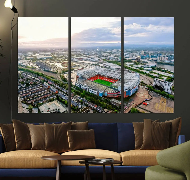 The "Old Trafford Manchester United Stadium Wall Art Canvas Print" adorns the room, showcasing an aerial view of Old Trafford at sunset. This three-panel wall art is perfect for any devoted Manchester United football fan.