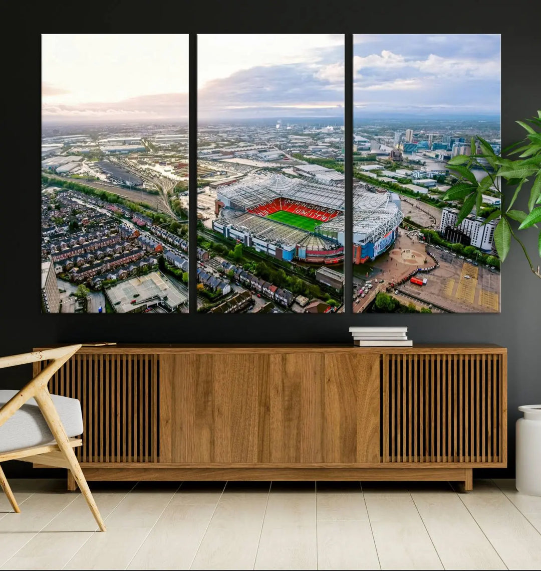 The "Old Trafford Manchester United Stadium Wall Art Canvas Print" adorns the room, showcasing an aerial view of Old Trafford at sunset. This three-panel wall art is perfect for any devoted Manchester United football fan.