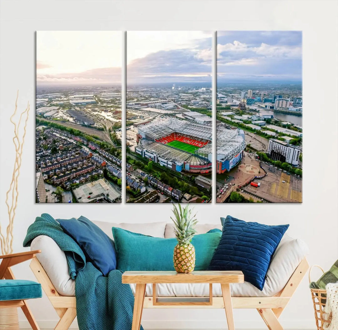 The "Old Trafford Manchester United Stadium Wall Art Canvas Print" adorns the room, showcasing an aerial view of Old Trafford at sunset. This three-panel wall art is perfect for any devoted Manchester United football fan.