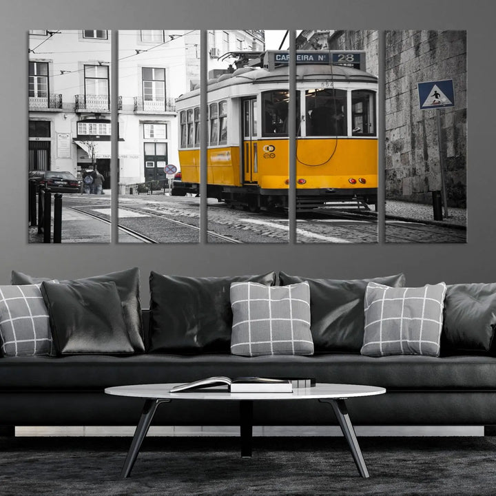 The wall art in the room features gallery-wrapped canvases with the "Old Yellow Tram Canvas Wall Art Canvas Print," which depicts a yellow tram against black-and-white city streets.