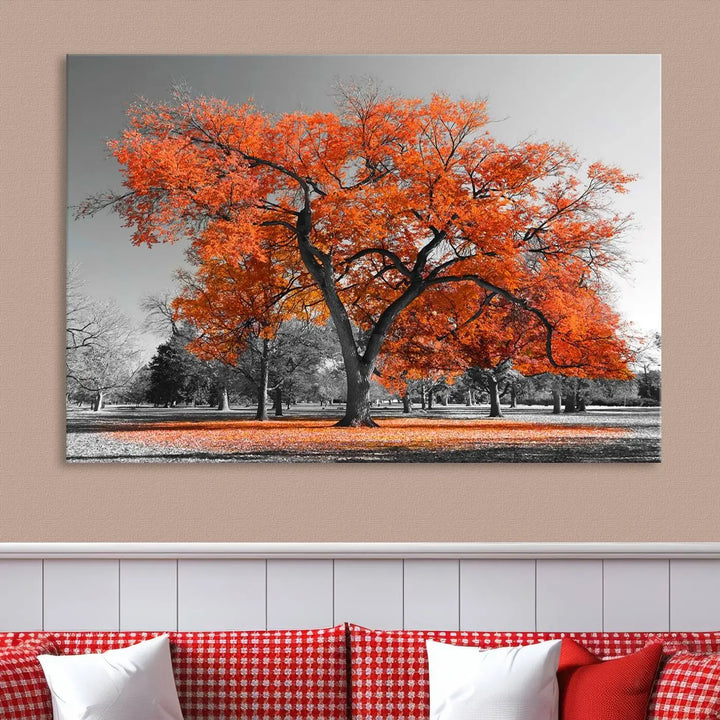 The "Orange Autumn Tree Canvas Wall Art Print" features a triptych of a tree with vibrant orange leaves set in a grayscale park. It's printed on museum-quality canvas and safeguarded by a UV-protective coating, making it the perfect artwork for any space.