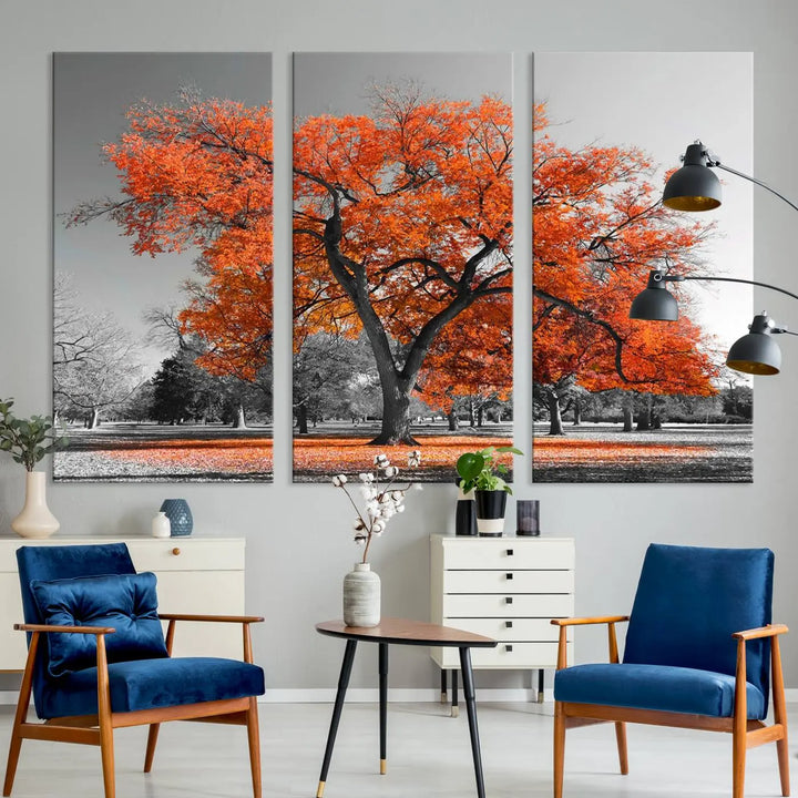 The "Orange Autumn Tree Canvas Wall Art Print" features a triptych of a tree with vibrant orange leaves set in a grayscale park. It's printed on museum-quality canvas and safeguarded by a UV-protective coating, making it the perfect artwork for any space.