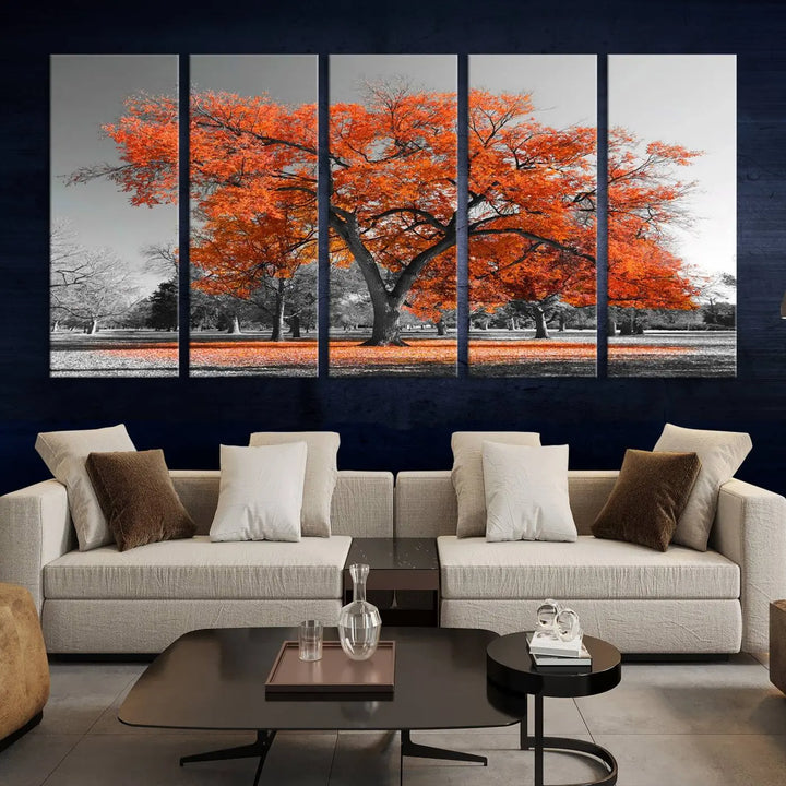 The "Orange Autumn Tree Canvas Wall Art Print" features a triptych of a tree with vibrant orange leaves set in a grayscale park. It's printed on museum-quality canvas and safeguarded by a UV-protective coating, making it the perfect artwork for any space.