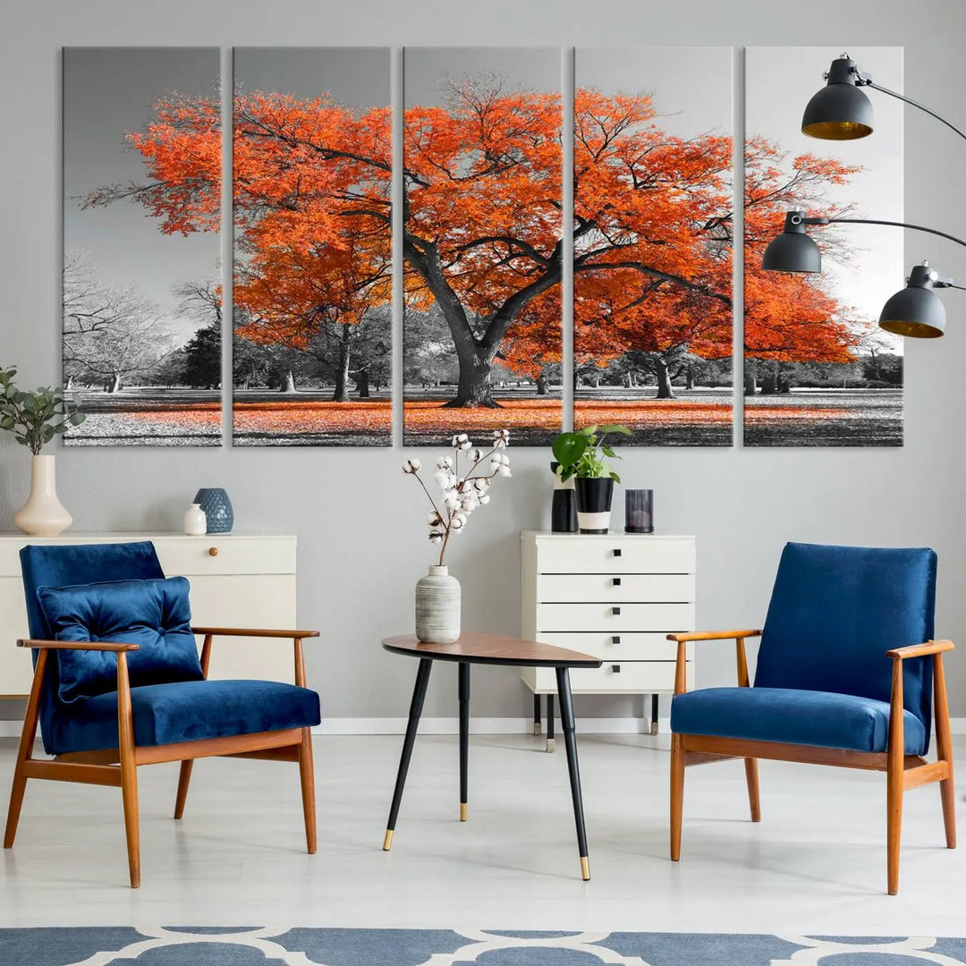 The "Orange Autumn Tree Canvas Wall Art Print" features a triptych of a tree with vibrant orange leaves set in a grayscale park. It's printed on museum-quality canvas and safeguarded by a UV-protective coating, making it the perfect artwork for any space.