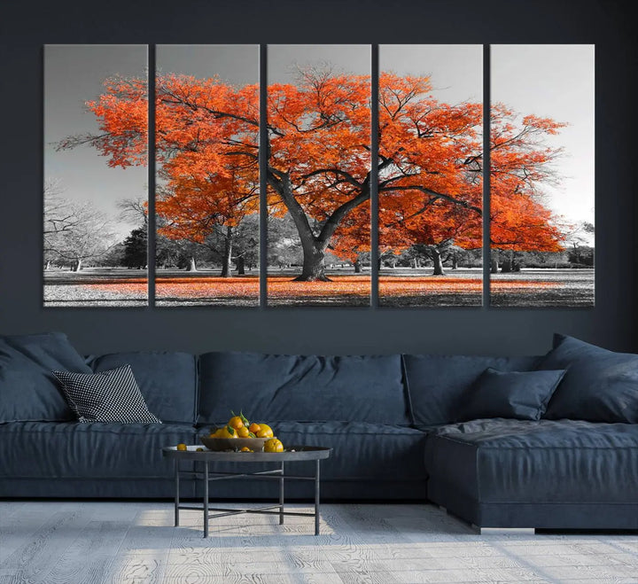 The "Orange Autumn Tree Canvas Wall Art Print" features a triptych of a tree with vibrant orange leaves set in a grayscale park. It's printed on museum-quality canvas and safeguarded by a UV-protective coating, making it the perfect artwork for any space.