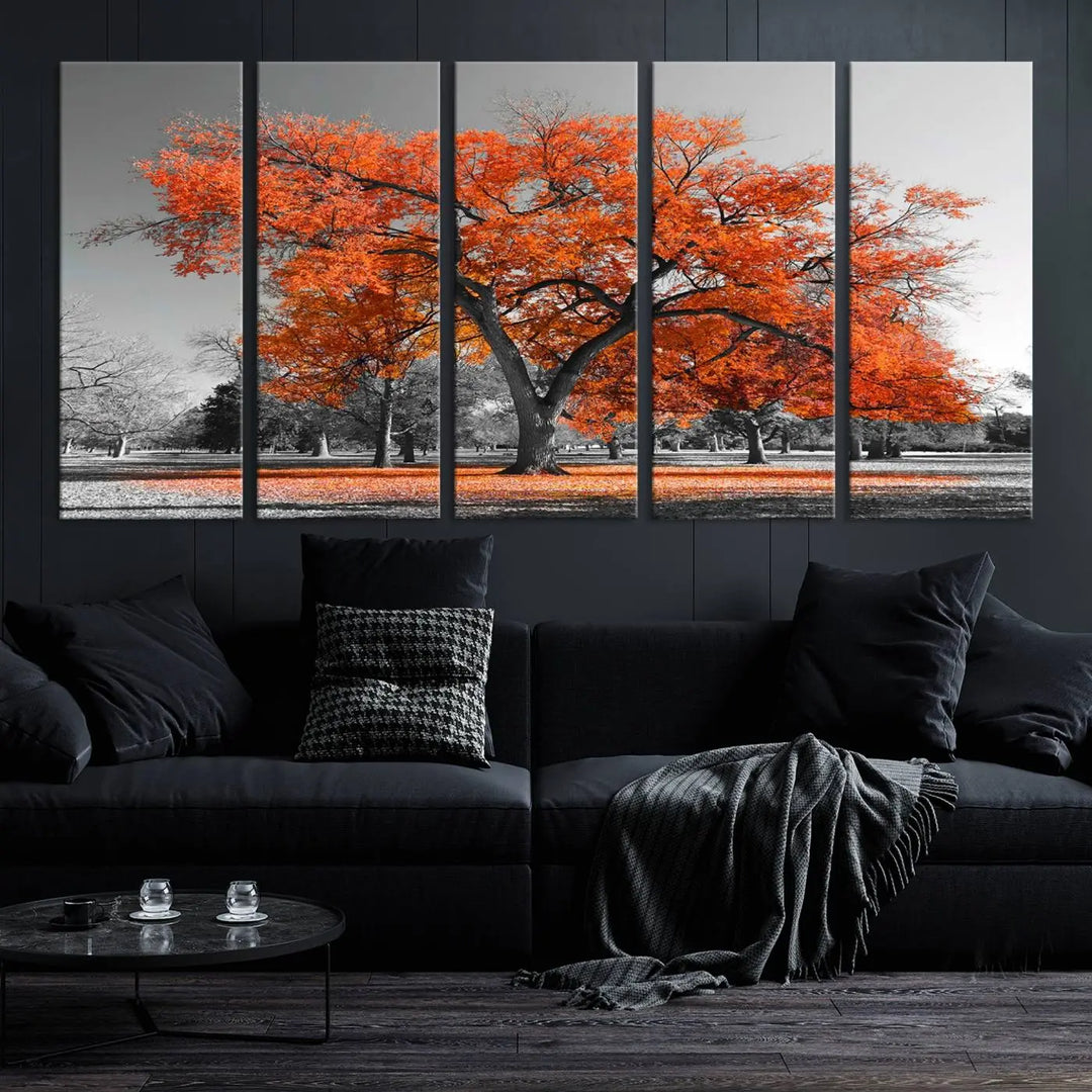 The "Orange Autumn Tree Canvas Wall Art Print" features a triptych of a tree with vibrant orange leaves set in a grayscale park. It's printed on museum-quality canvas and safeguarded by a UV-protective coating, making it the perfect artwork for any space.