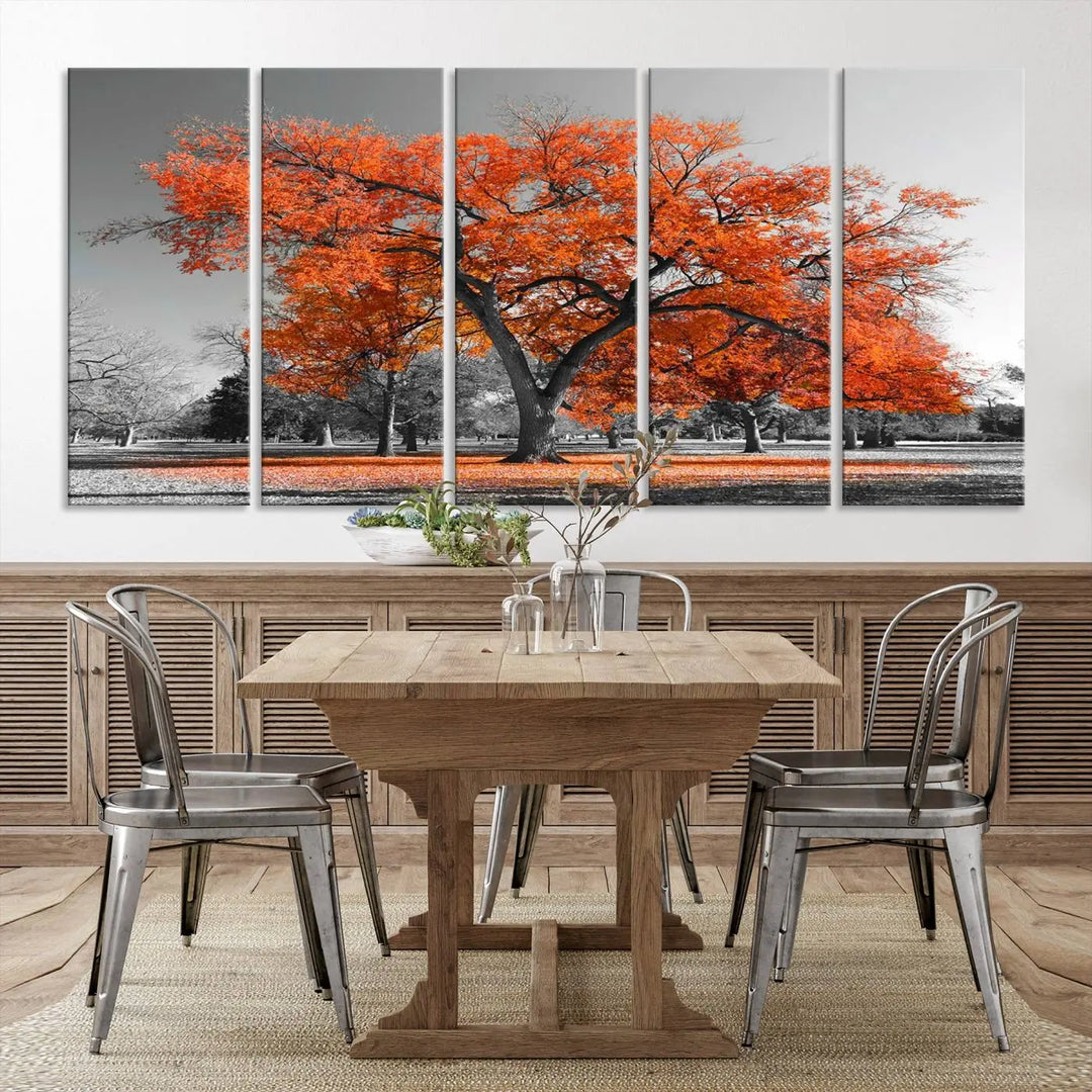 The "Orange Autumn Tree Canvas Wall Art Print" features a triptych of a tree with vibrant orange leaves set in a grayscale park. It's printed on museum-quality canvas and safeguarded by a UV-protective coating, making it the perfect artwork for any space.