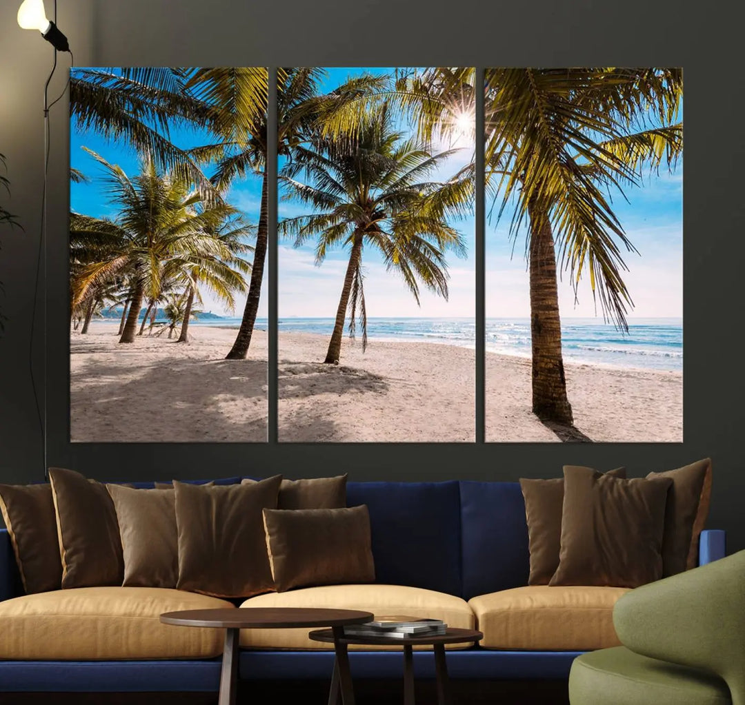 A living room showcasing the Palm Beach Tropical Island Wall Art Canvas Print, a triptych of palm trees on a sandy beach, offered in museum-quality canvas.